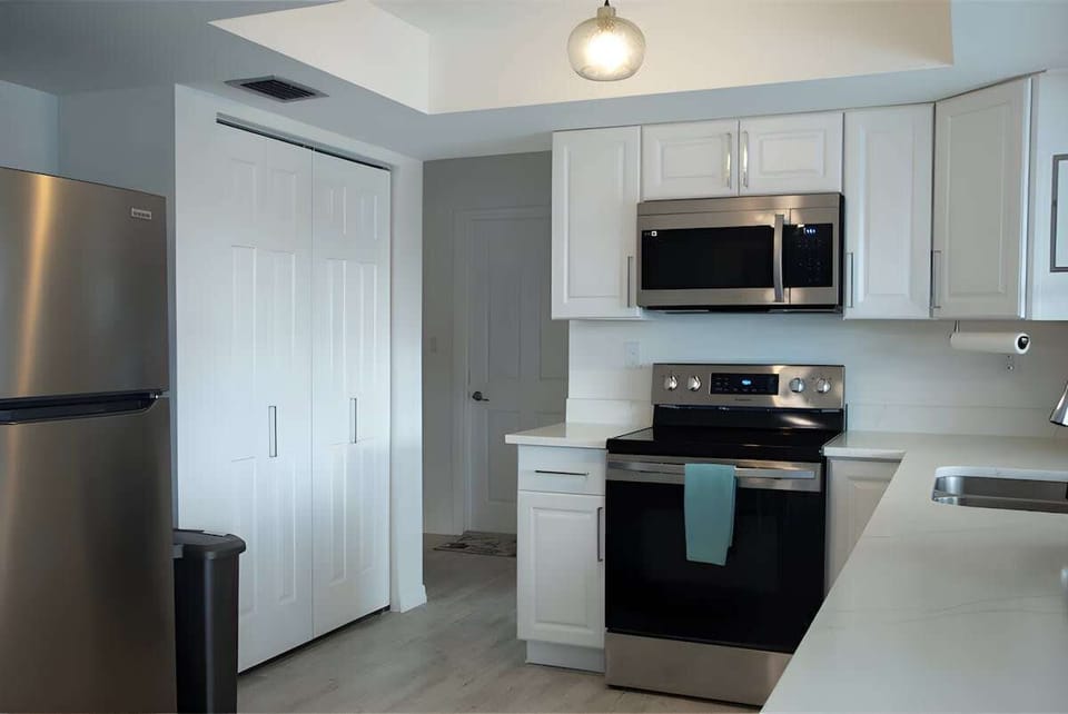 ""Open-concept kitchen and dining area, where cooking and conversations flow seamlessly."
