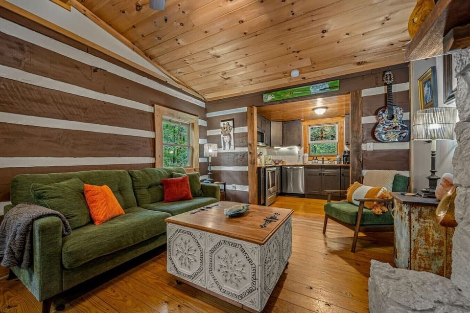 Whether you`re sipping coffee by the fireplace, lounging under string lights on the porch, or exploring nearby trails, this cabin offers a memorable getaway with personality.