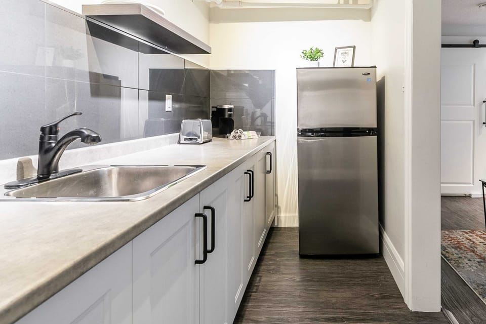 Functional Kitchen Space Featuring A Large Fridge And Ample Countertops