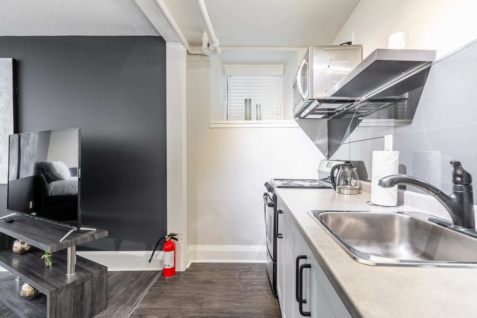 Well-Equipped Kitchen Featuring A Modern Sink And Stove