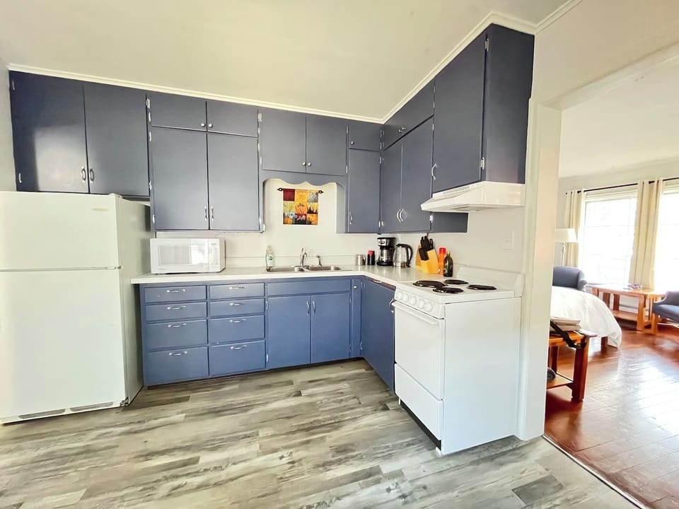 The spacious kitchen features original built-ins and moldings, stocked with all the essentials.