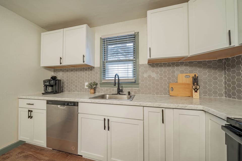 - Spacious countertop kitchen setup with full amenities for cooking   - Dishwasher coffee maker and storage space for easy meal prep   - Bright window view brings in natural light for a fresh vibe