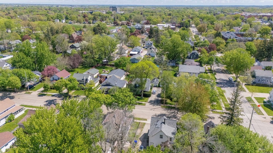 - Aerial view showcases a peaceful tree filled neighborhood perfect for relaxing stays   - Spacious streets and greenery create a calm guest friendly environment   - Ideal location close to local dining parks and nearby attractions