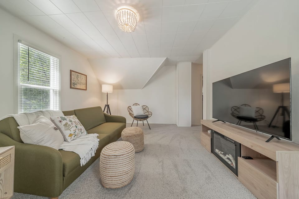 - Bright living room with comfy seating   - Relaxing space with TV and soft natural light   - Perfect for cozy evenings during your stay