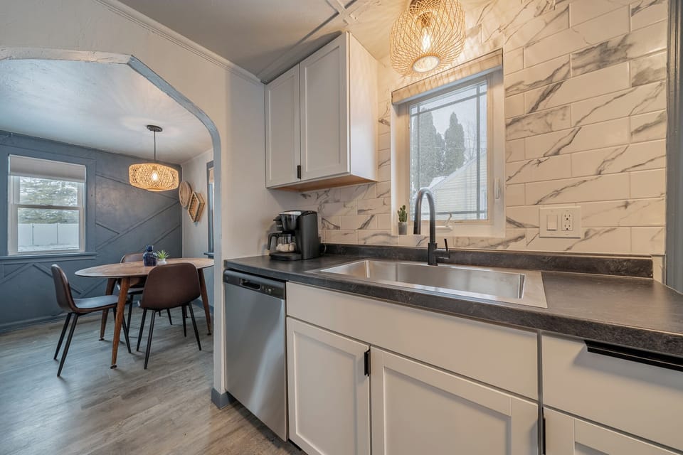 - Clean kitchen design with bright window light stylish backsplash and spacious counter   - Well arranged layout offers convenience for cooking and daily routines   - Perfect for guests wanting a polished guest ready meal space