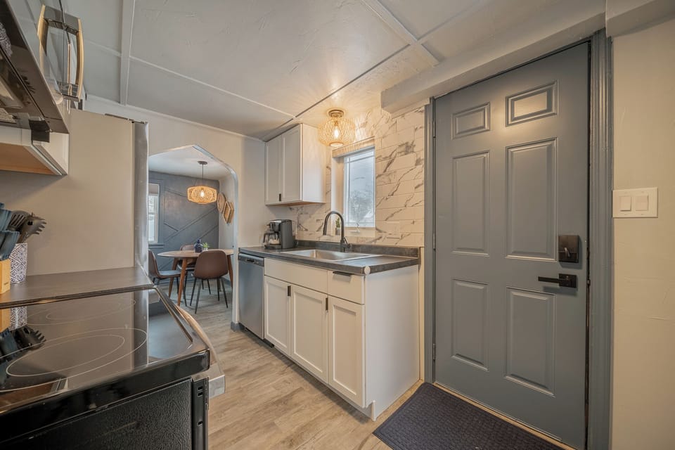 - Bright kitchen entry with updated cabinets stainless appliances and modern finishes   - Natural light fills this functional cooking space ready for guest use   - Easy access to dining and living areas creates a smooth stay flow