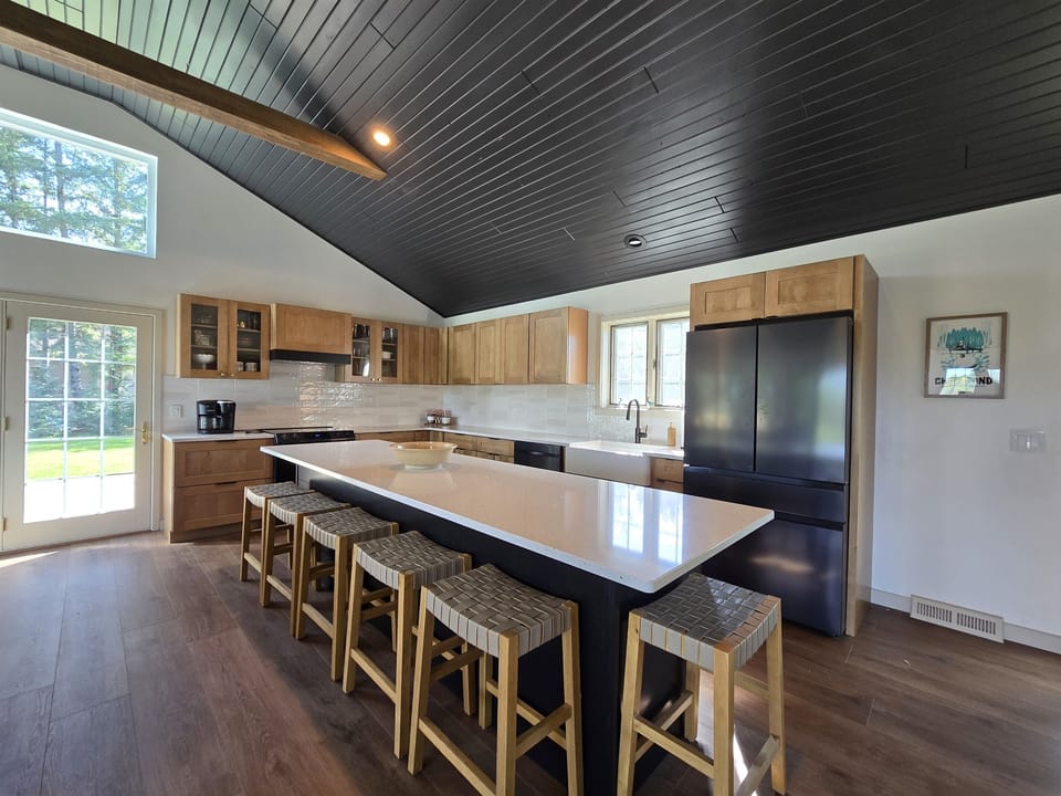 - Cook and gather in this bright open kitchen space   - Spacious island seating makes meals feel effortless   - Modern appliances and warm wood tones welcome you