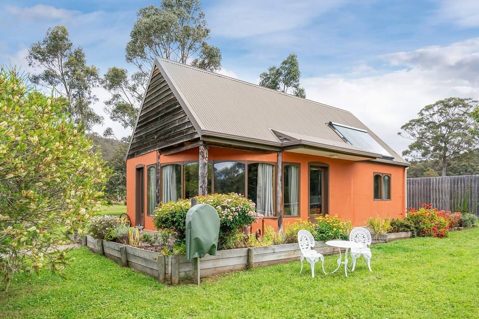 Explore the beautiful exterior of this cottage, nestled amid blossoming gardens and rolling vineyard lawns. 