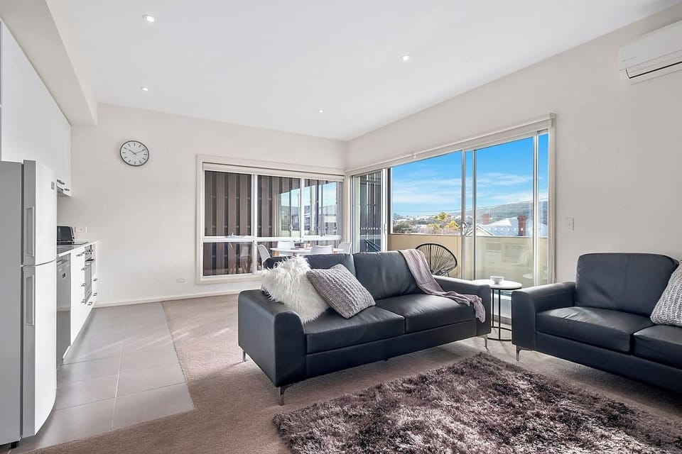 Open plan living, dining and a compact kitchen maximise space in this apartment.