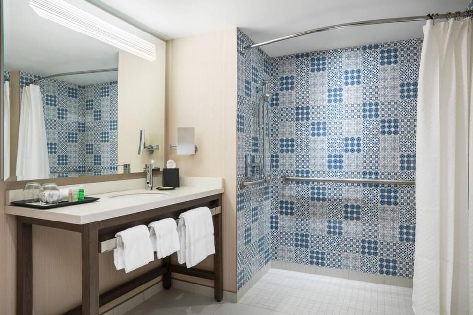 Refresh under a roomy shower with chic patterned tile.