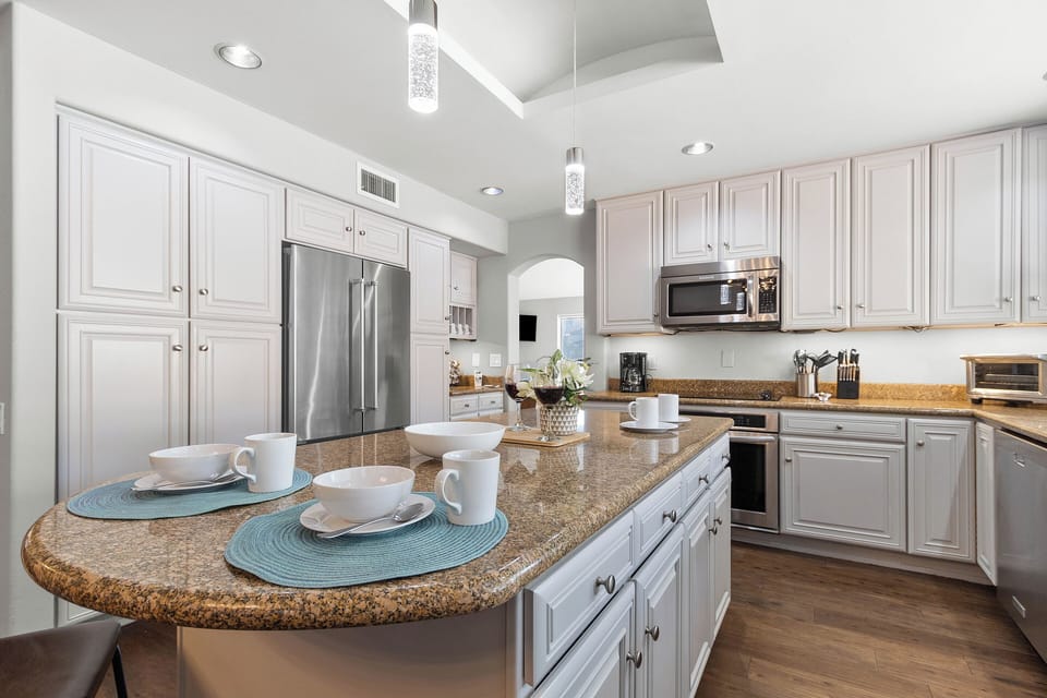 Large kitchen is fully equipped with stainless steel appliances