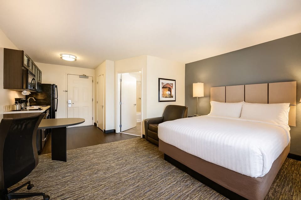 Unwind in a bright studio with cozy bed and kitchenette.