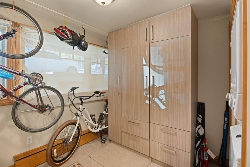 The first floor features a washer and dryer and storage room for equipment
