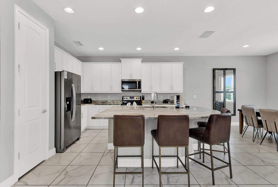 Create culinary magic in our spacious kitchen, complete with a large island and high seating for a perfect gathering spot.