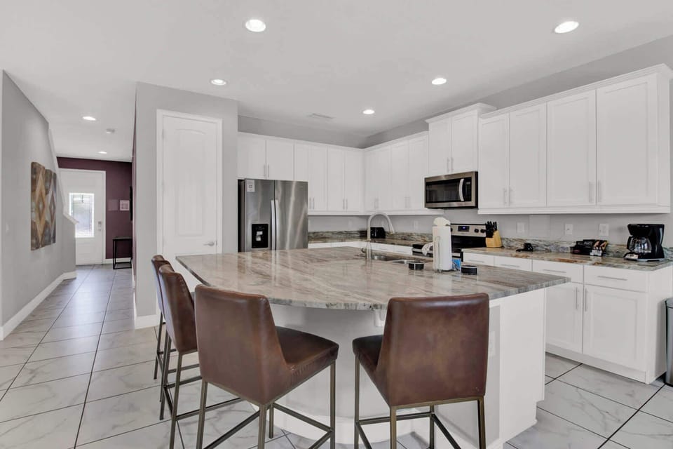 Create culinary magic in our spacious kitchen, complete with a large island and high seating for a perfect gathering spot.