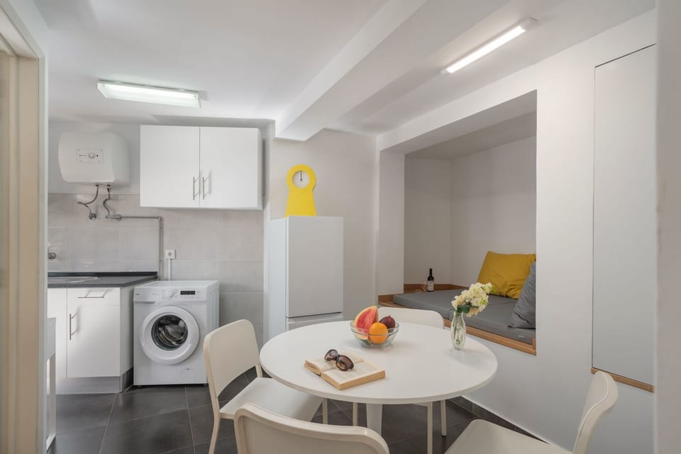 The Dining Area Of Vintage Garden Apartment By Ourmadeira Showing The Reading Nook And Washing Machine