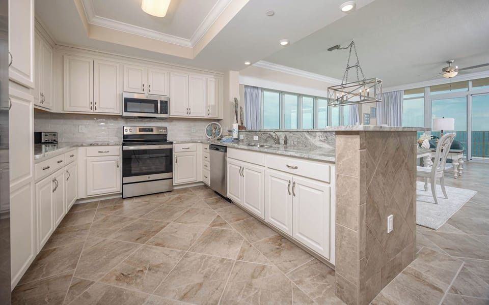 Prepare meals in this kitchen with elegant cabinetry, stainless appliances, and spacious countertops
