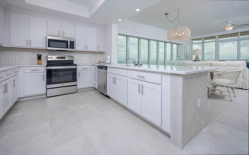 Prepare meals in this kitchen with elegant cabinetry, stainless appliances, and spacious countertops