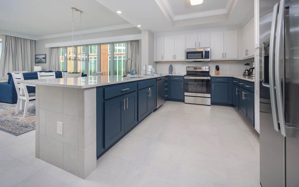 Prepare meals in this kitchen with elegant cabinetry, stainless appliances, and spacious countertops