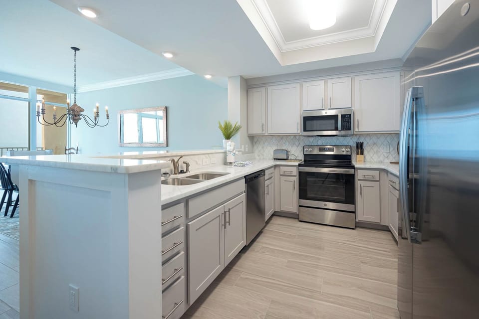 Prepare meals in this kitchen with elegant cabinetry, stainless appliances, and spacious countertops