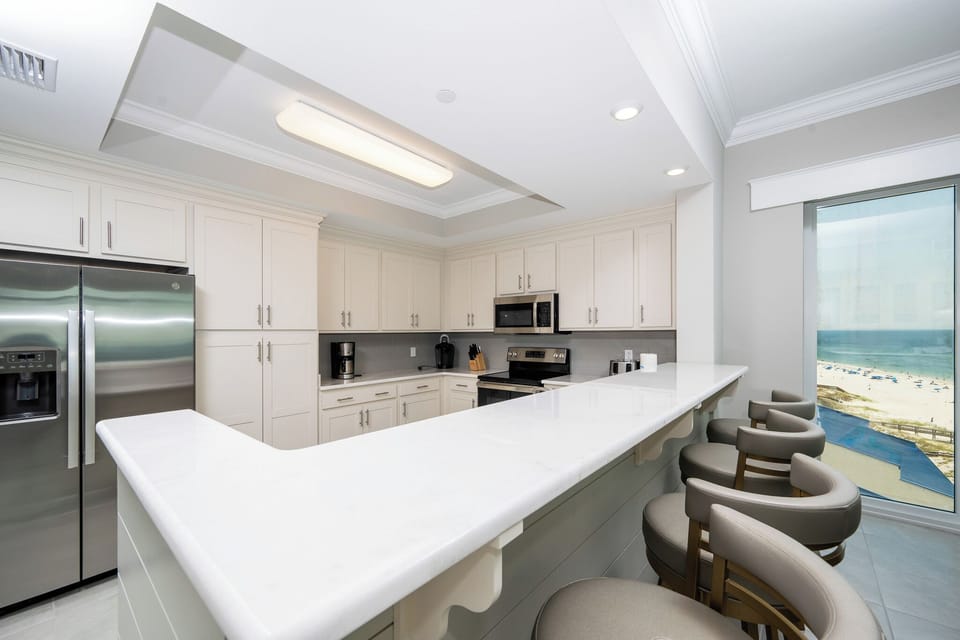 Wake up with morning coffee at the breakfast bar and get ready for a beach day in this stylish space