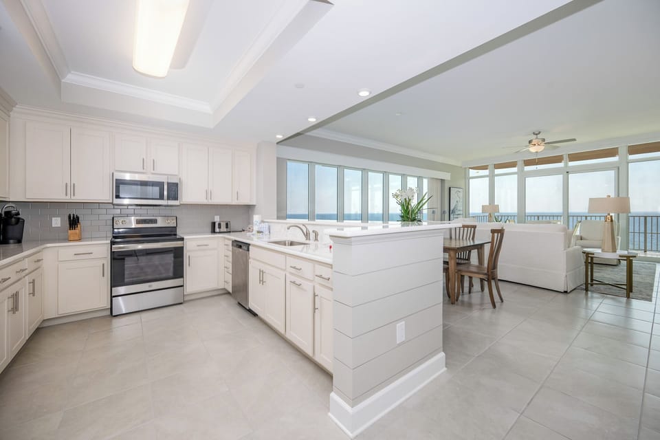 Prepare meals in this kitchen with elegant cabinetry, stainless appliances, and spacious countertops
