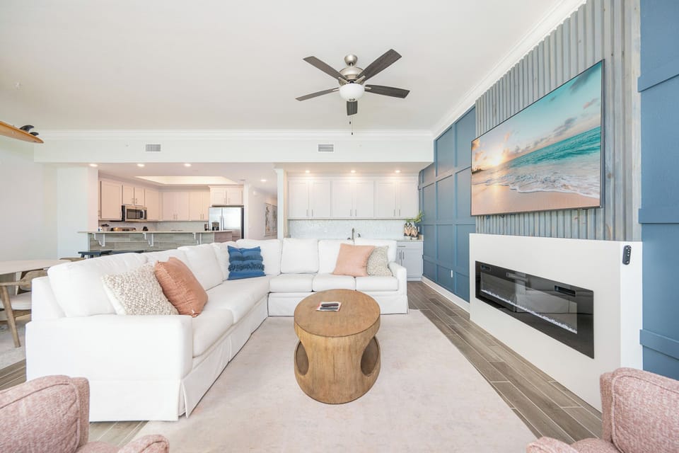 Relax on the sectional with a queen sleeper in this inviting family room with a cozy fireplace on the media wall