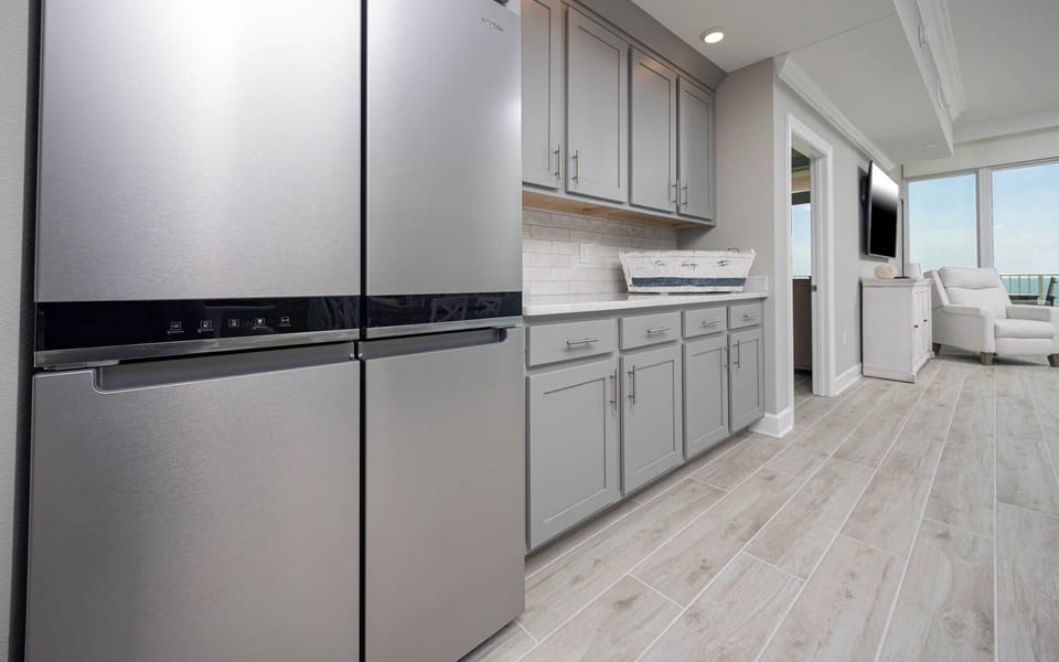 Grab a chilled drink from the modern stainless fridge or create your favorite cocktail at the wet bar