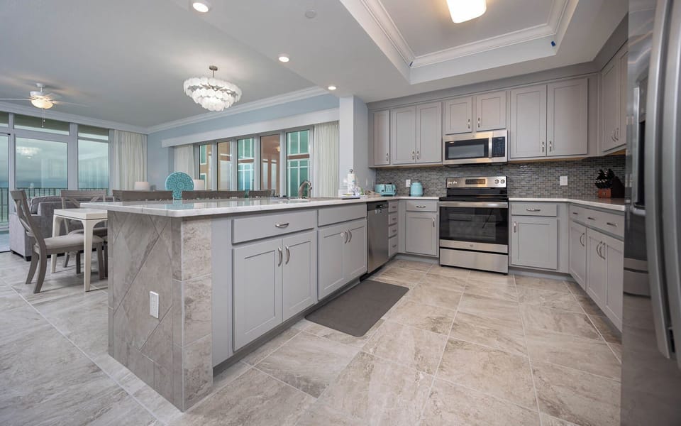 Prepare meals in this kitchen with elegant cabinetry, stainless appliances, and spacious countertops