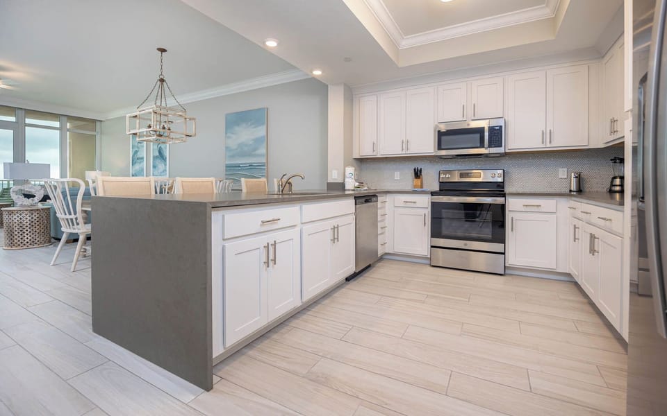 Prepare meals in this kitchen with elegant cabinetry, stainless appliances, and spacious countertops