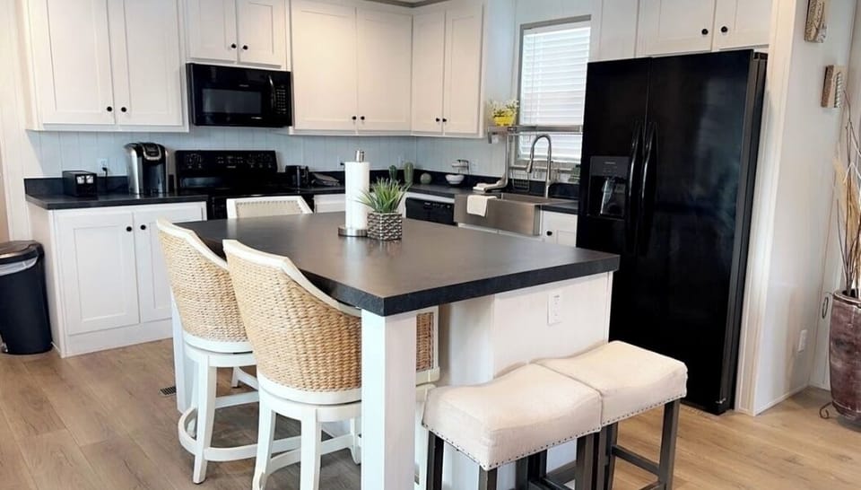 Open concept kitchen black appliances and dinning island 