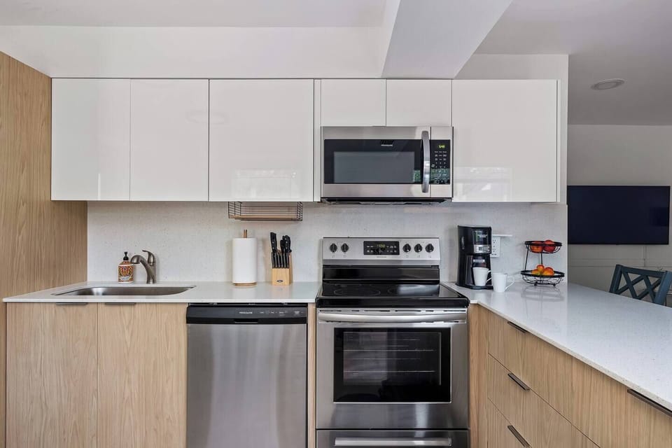 Cook and gather in this bright, airy kitchen, filled with natural light and modern touches for a warm and inviting atmosphere.