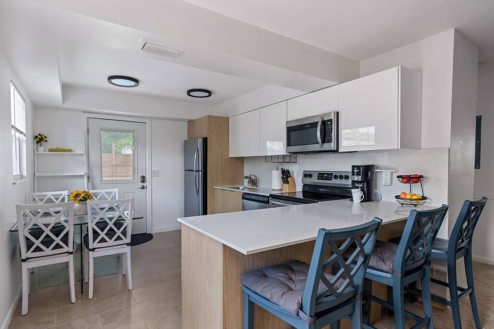 Cook and gather in this bright, airy kitchen, filled with natural light and modern touches for a warm and inviting atmosphere.