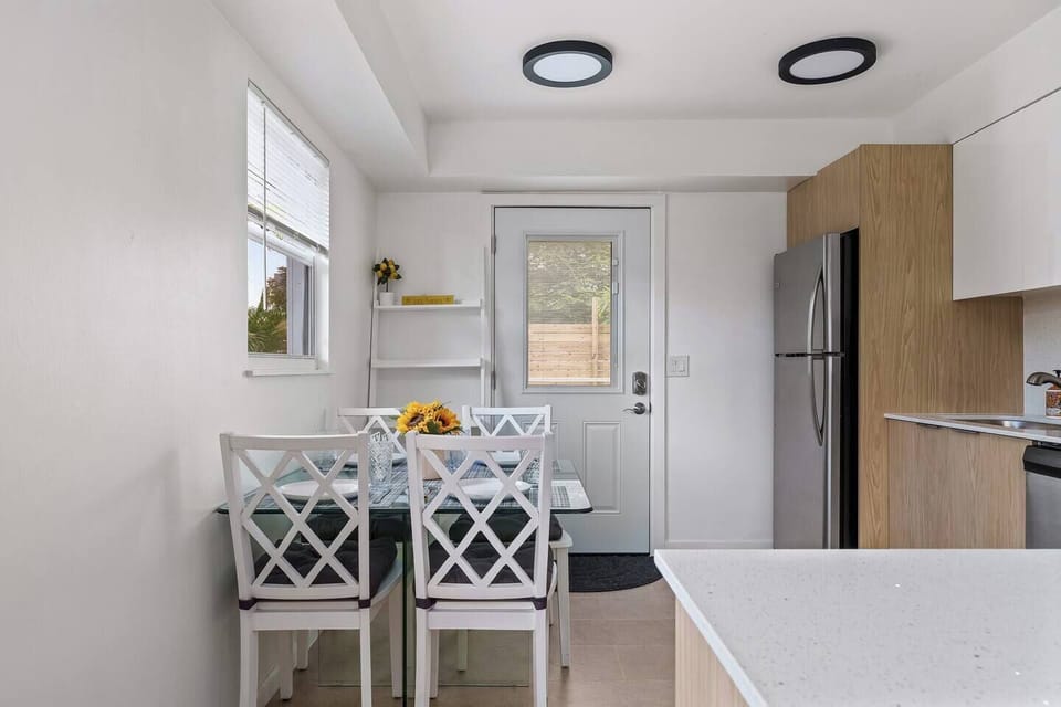 Cook and gather in this bright, airy kitchen, filled with natural light and modern touches for a warm and inviting atmosphere.