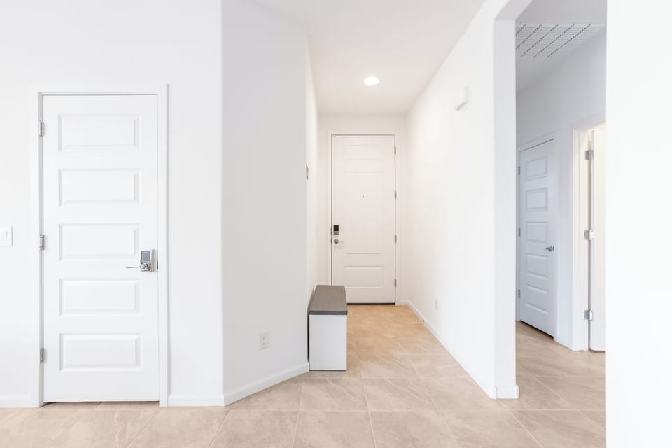 Foyer with padded shoe rack to store all your shoes, sandals, heels, and boots