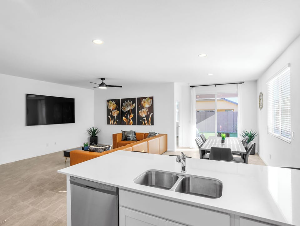 Open space with dining table seats 6 and 4 barstools at the kitchen island