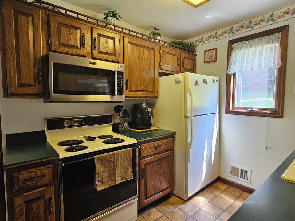 Full kitchen with a view of the back of the property