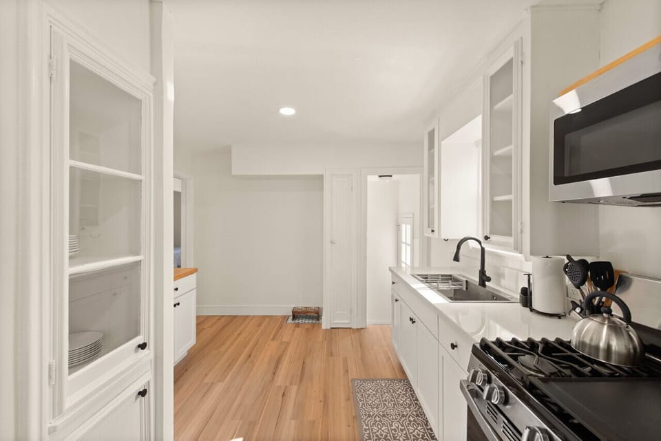 Sunshine streams into this spotless space, illuminating a kitchen ready for culinary adventures.