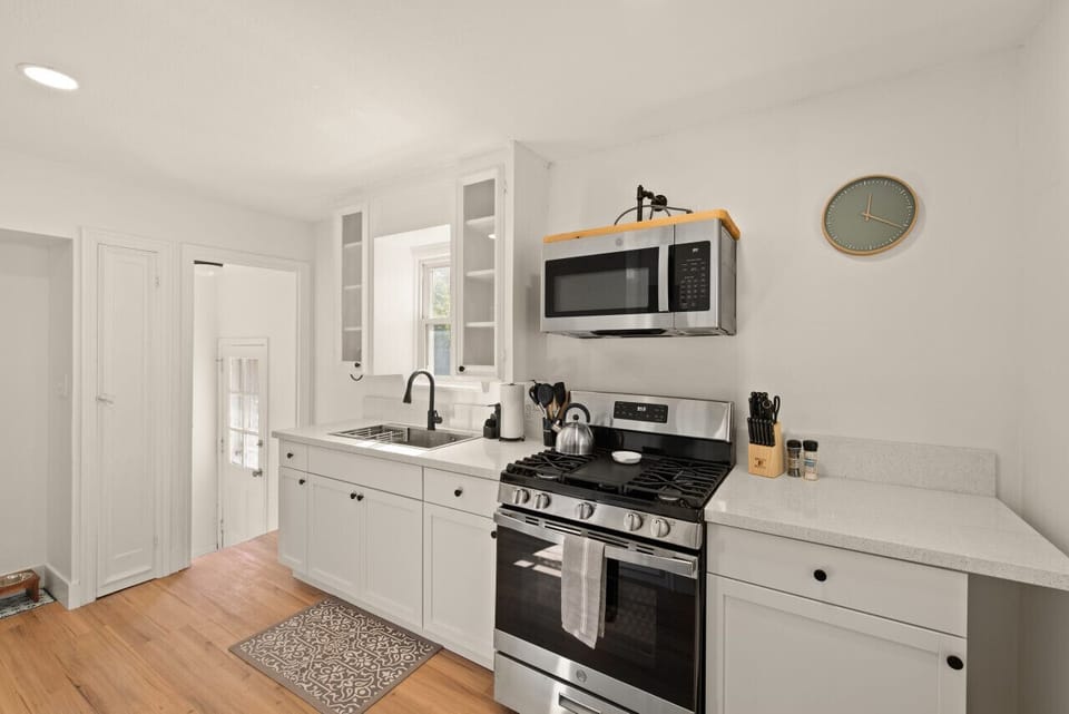 Minimalist chic meets modern comfort in this bright and inviting kitchen.  Soaking up the light!