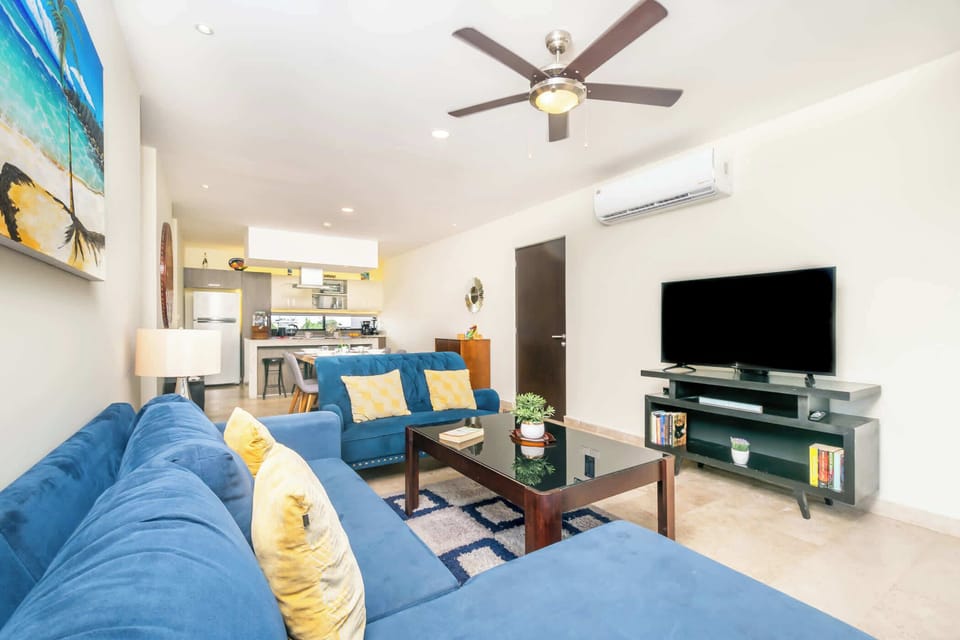 The sitting room has a cozy sofa facing a Smart TV