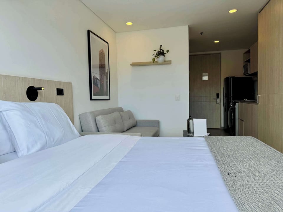 Another angle of the bedroom showing bed and nightstands.