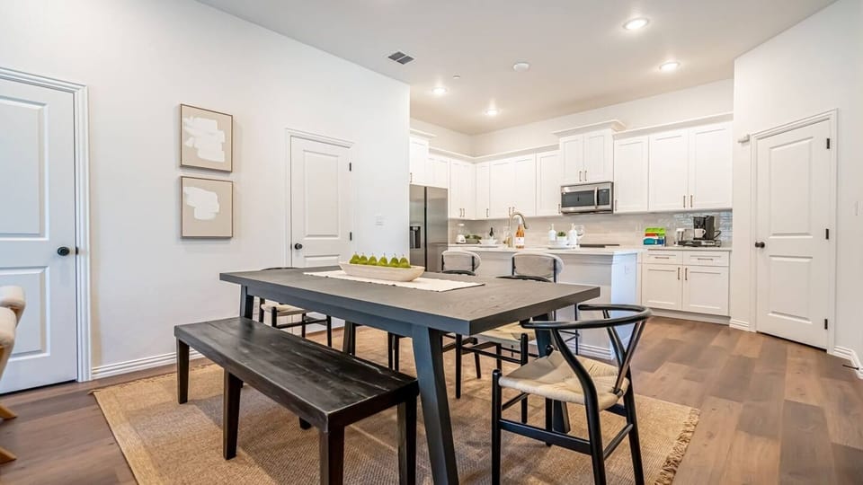 Gather around and eat like you live here. The dining area seats your whole group and flows seamlessly into the full kitchen — ideal for group travel, family stays, and anyone who wants more than a hotel room near Globe Life Field.