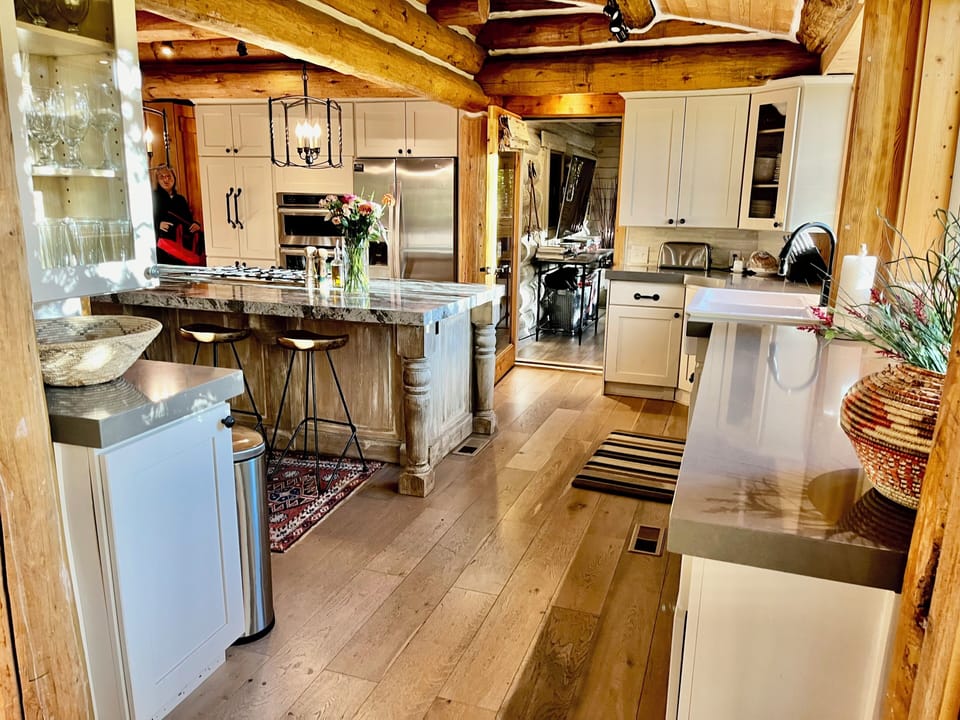 Chefs kitchen with large custom granite island just off the great room