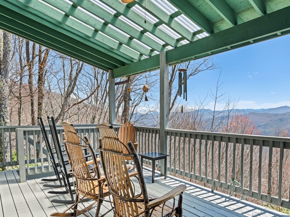 Covered deck with rocking chairs and breathtaking long-range mountain views.
