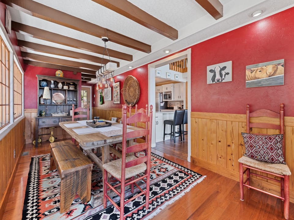 Charming dining room with rustic beams, colorful accents, and a welcoming feel.