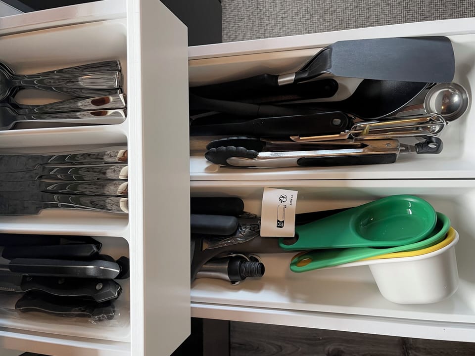 All the utensils for baking, grilling, cooking. Silverware in top hidden drawer.