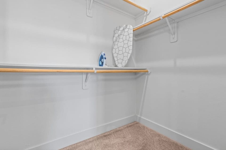 Modern built-in closets with hangers and shelving, perfect for keeping your clothes organized during your stay.
