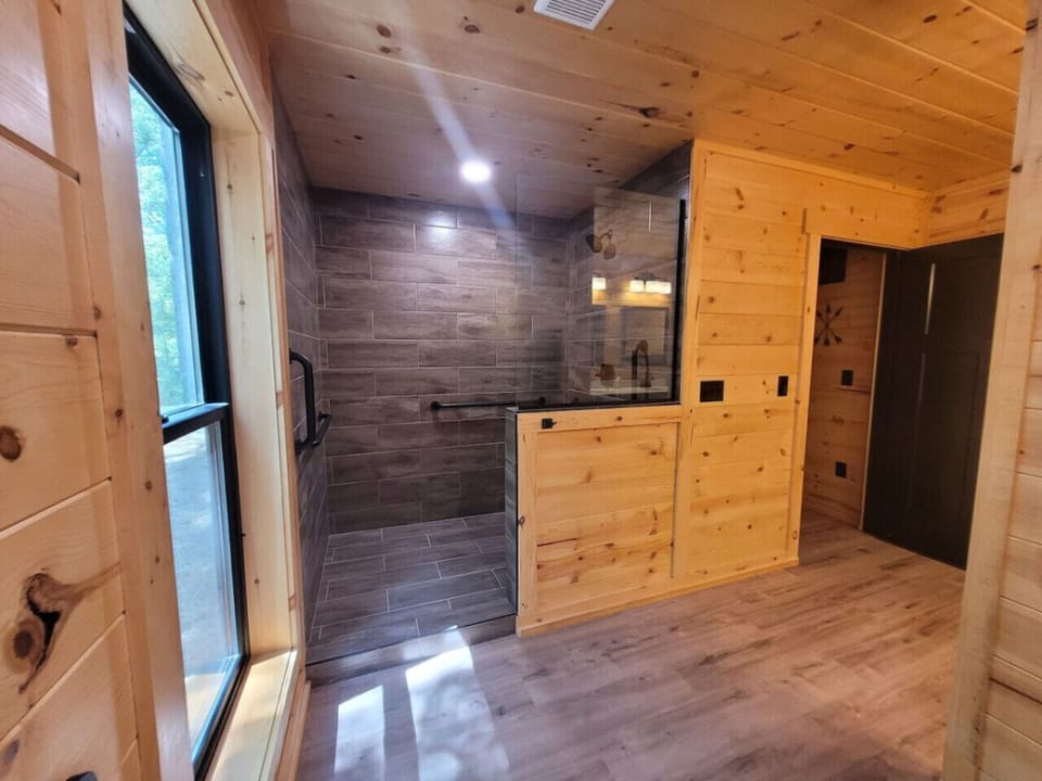 Spa-like walk-in shower with modern tile and glass doors 🚿✨ — the perfect place to refresh and unwind after a day exploring the trails 🌲🤍