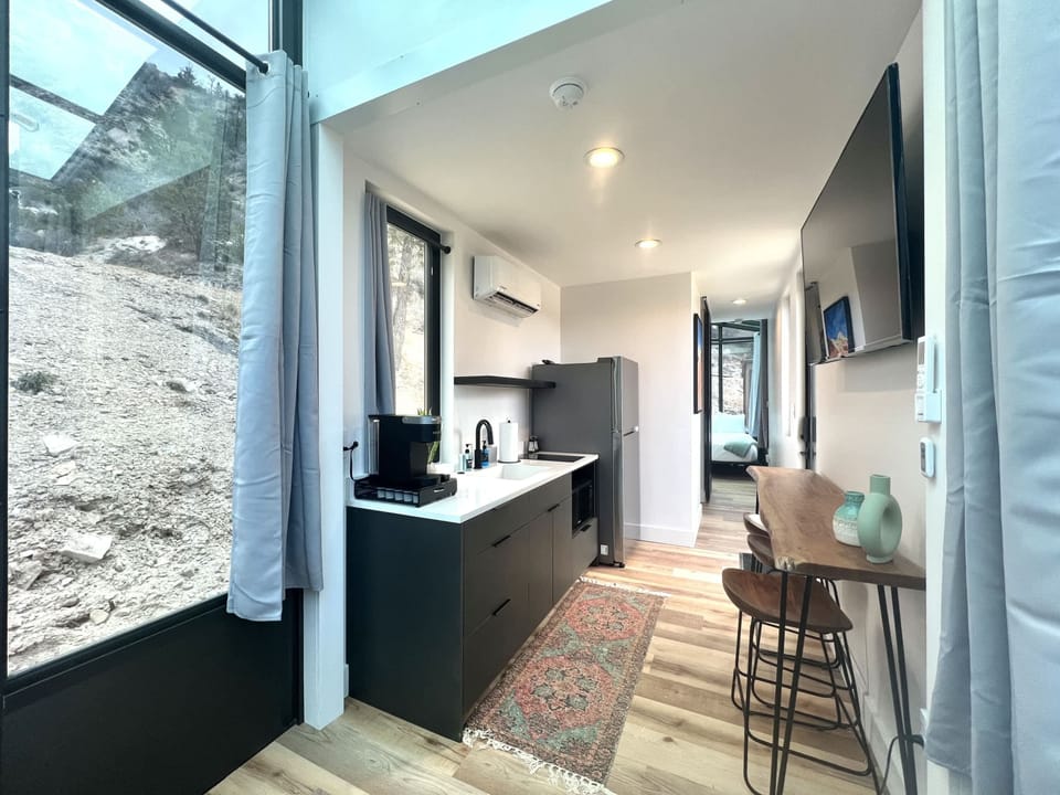 Red Hollow kitchen area with a full refrigerator and cooking essentials for easy meals during your stay.
