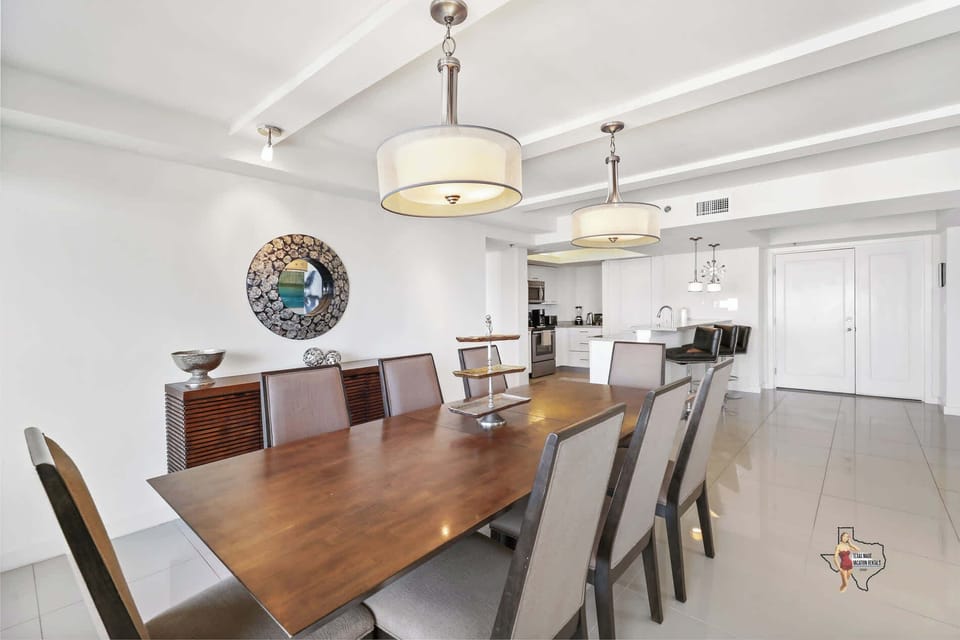 Spacious dining area featuring a wooden table for eight guests.